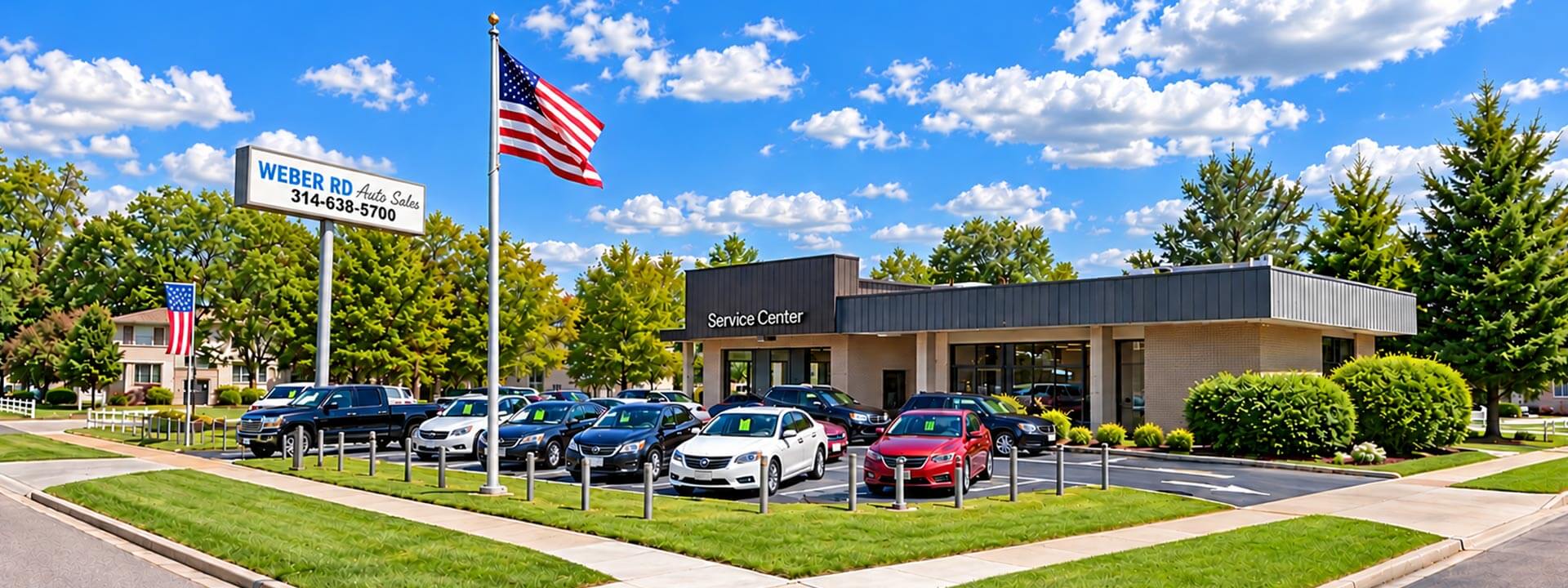 Weber RD Auto Sales service center building with cars parked in the lot and two American flags flying.